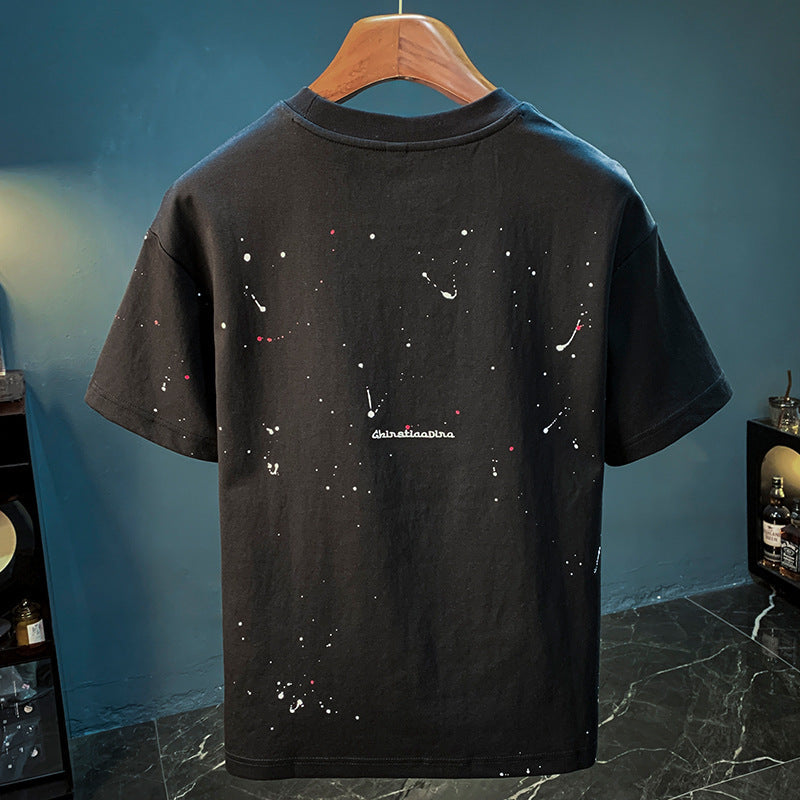 Studio Tee paint-splatter design side view